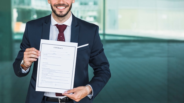 Close-up smiley lawyer holding a contract 