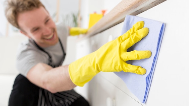 Close-up smiley man cleaning