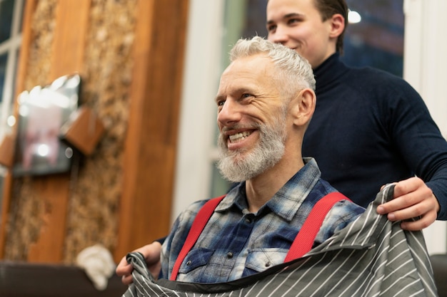 Close up smiley man at hairdresser shop