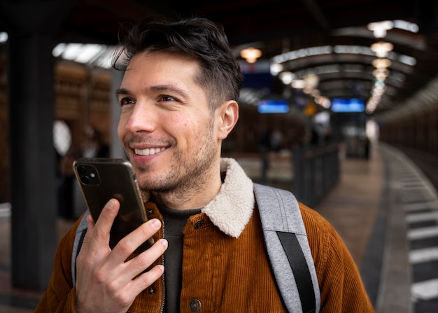 Close up smiley man holding device