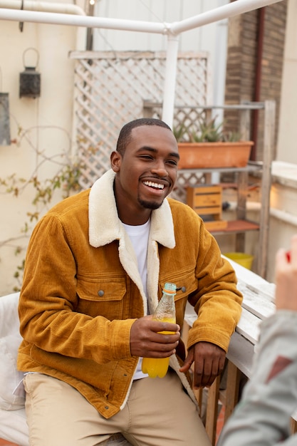 Free photo close up smiley man holding drink