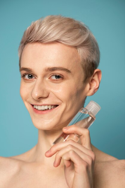 Close up smiley man holding serum