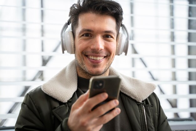 Close up smiley man holding smartphone