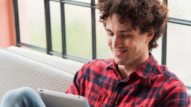 Close-up smiley man holding tablet