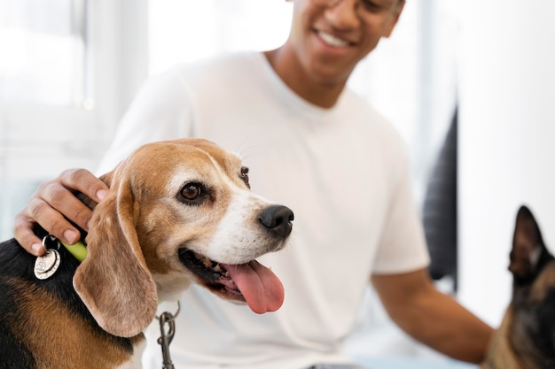 Free photo close up smiley man petting dog