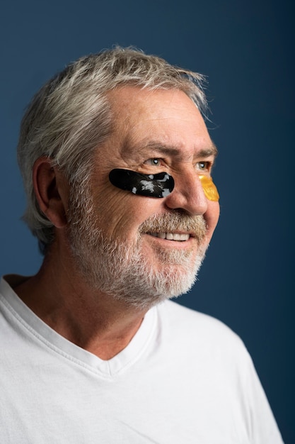 Free photo close up smiley man wearing eyepatches