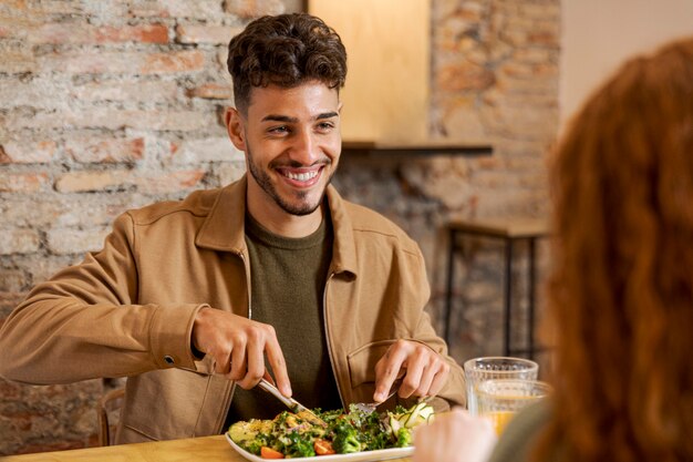 Close up smiley man and woman at table