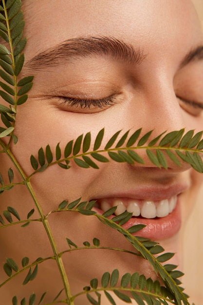 Close up smiley model posing with plant