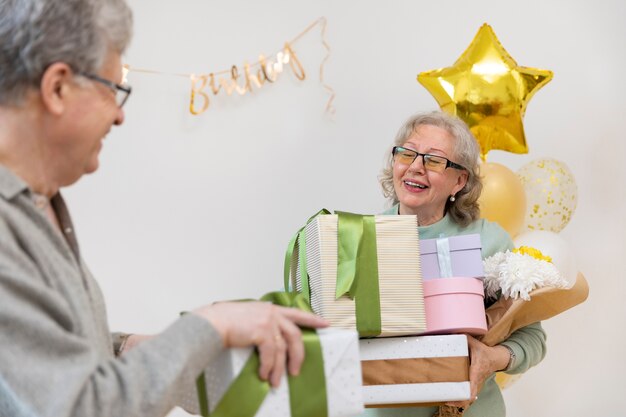 Close up smiley people holding presents