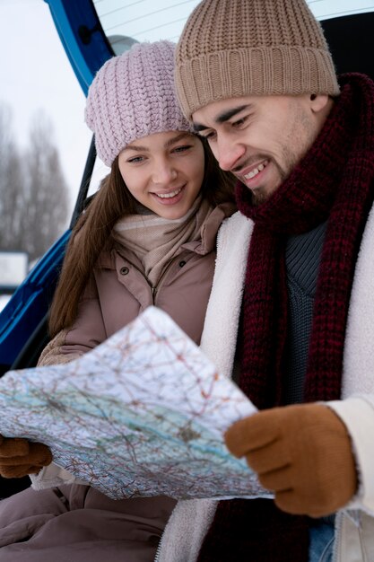 Close up smiley people looking at map