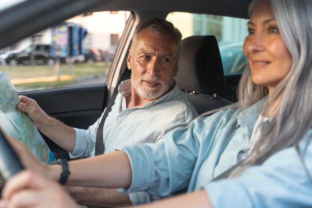 Close up smiley senior people in car