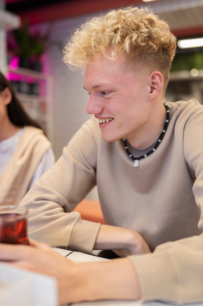 Free photo close up smiley teen with drink