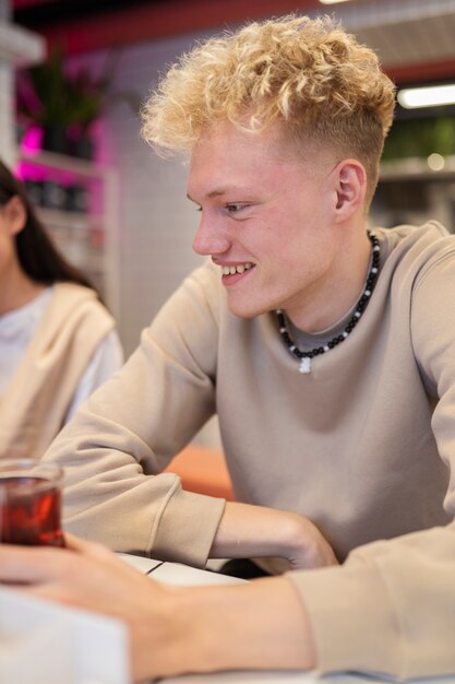 Close up smiley teen with drink