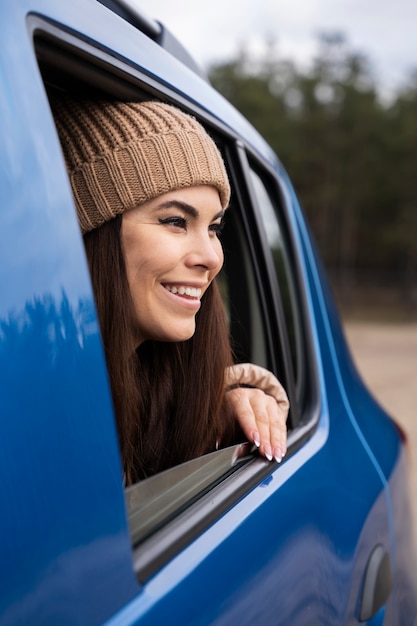Close up smiley woman in blue car