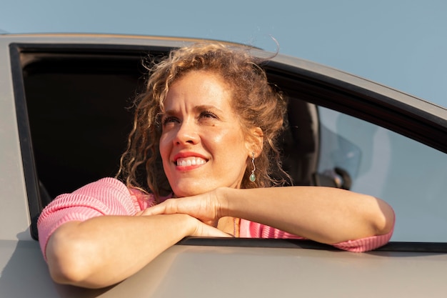 Free photo close up smiley woman in car