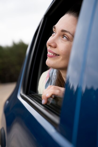 Close up smiley woman in car