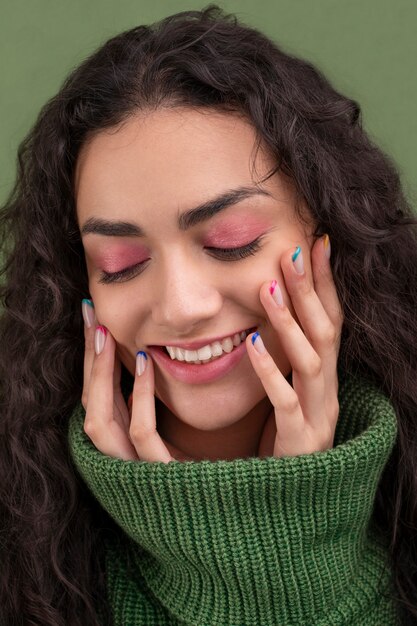 Close up smiley woman and colorful manicure