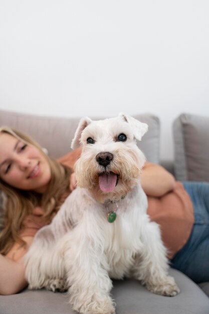 Close up smiley woman and dog on couch