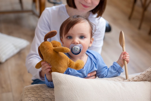 Close up smiley woman holding cute baby