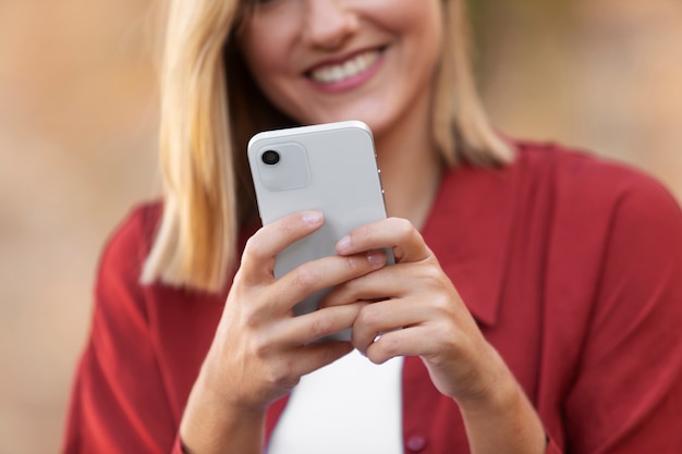 Close up smiley woman holding device