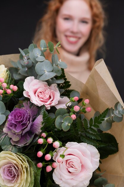 Close up smiley woman holding flowers