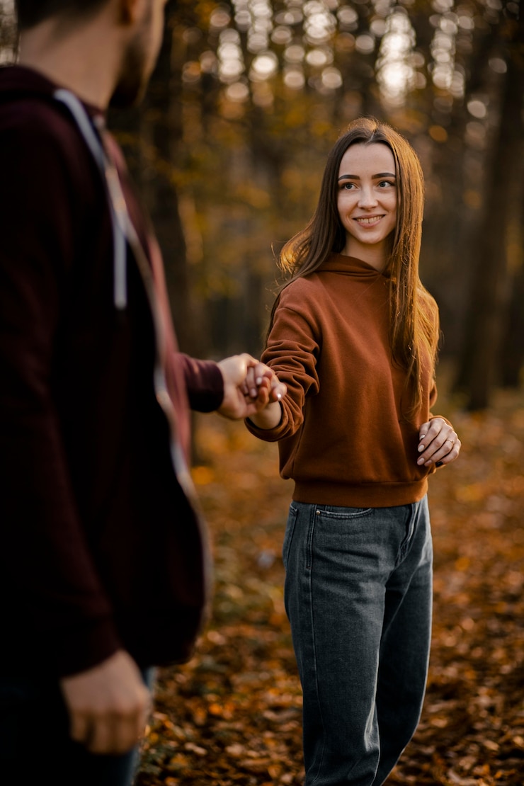 Free Photo close-up smiley woman holding man's hands