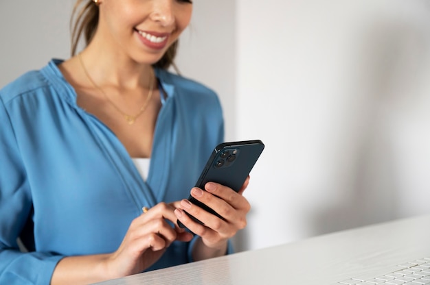 Close up smiley woman holding smartphone