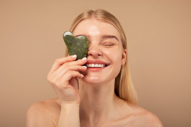 Free photo close up smiley woman holding tool