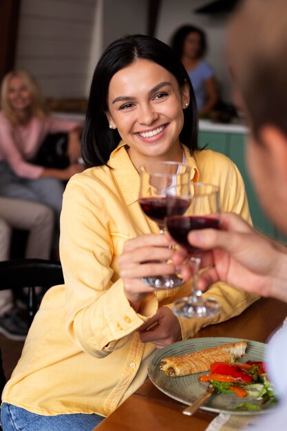 close up smiley woman holding wine glass