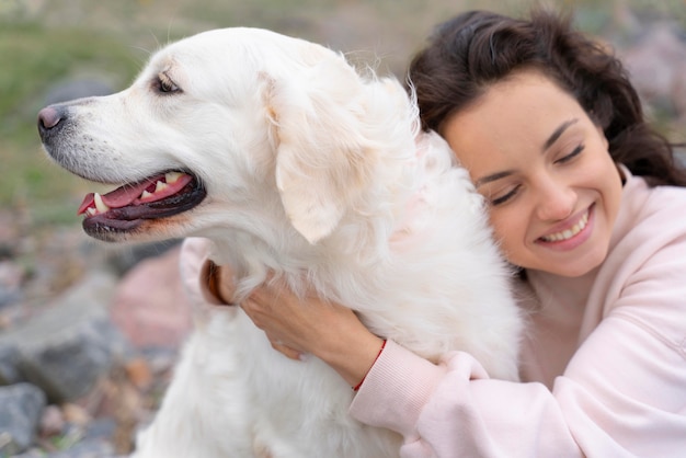 Close up smiley woman hugging dog