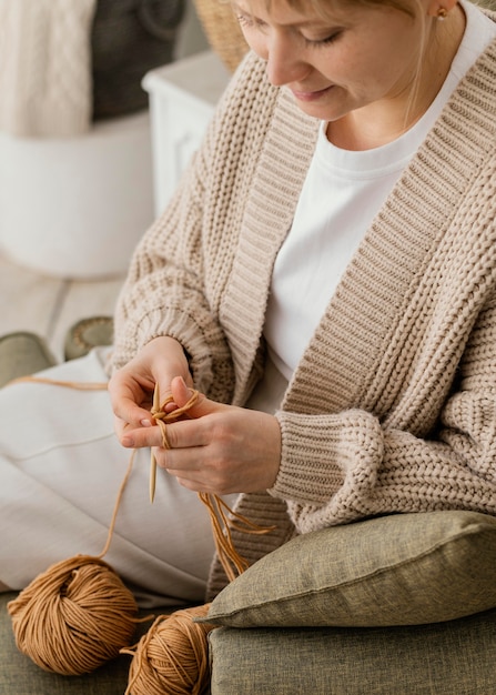 Close-up smiley woman knitting