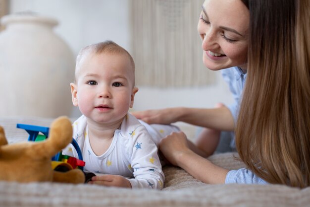 Close up smiley woman looking at baby