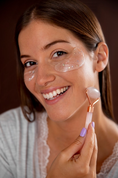 Foto gratuita primo piano sorridente donna che massaggia il viso