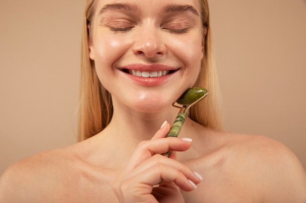 Close up smiley woman massaging face