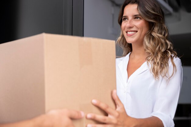 Close up smiley woman receiving pack