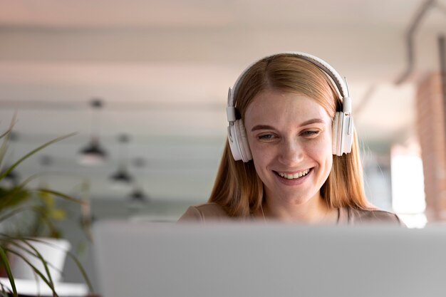 Close up smiley woman wearing headphones