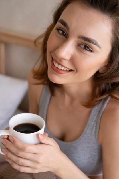 コーヒーで笑顔の女性をクローズアップ