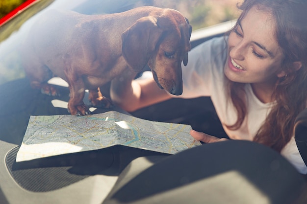 Close up smiley woman with dog and map