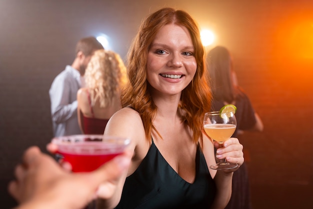 Close up smiley woman with drinks