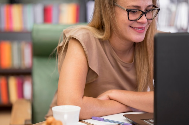 Close-up smiley woman with laptop