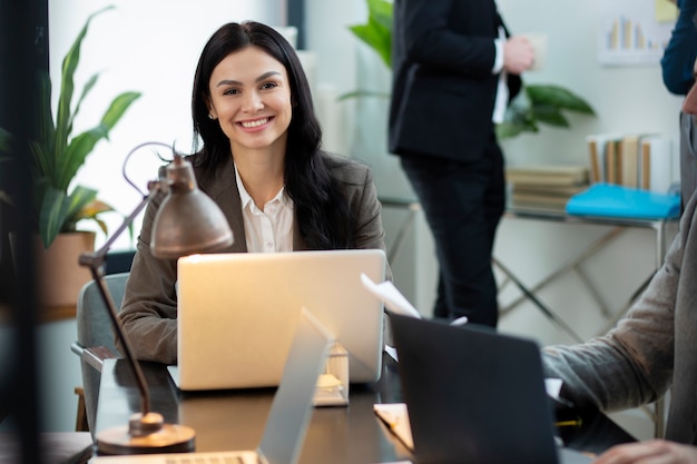 Close up smiley woman with laptop