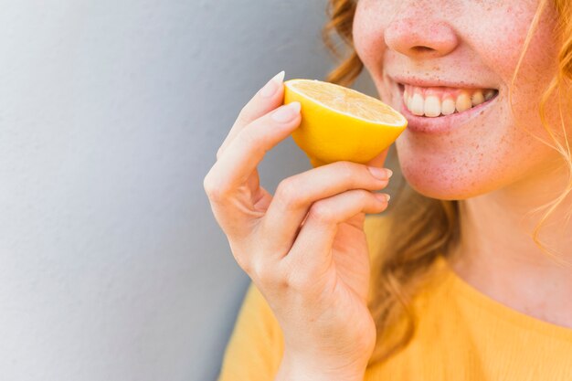 Close-up smiley woman with lemon