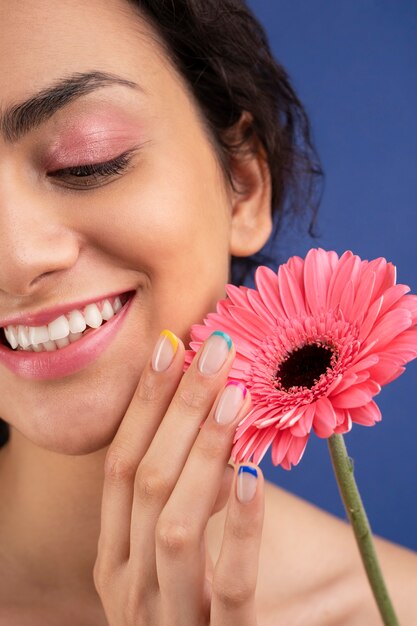 Close up smiley woman with pink flower