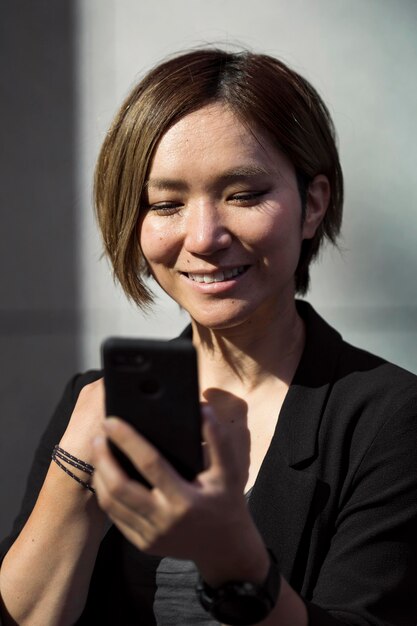 Close up smiley woman with smartphone