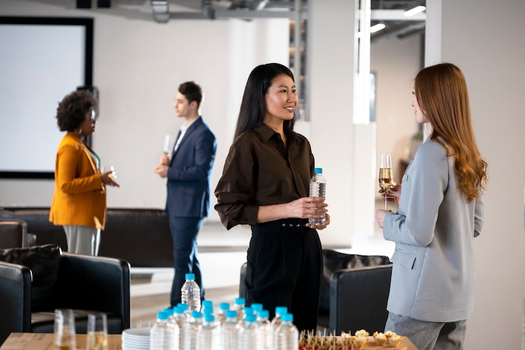 Free Photo close up smiley women chatting at company event