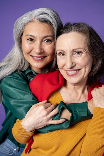 Close up smiley women hugging