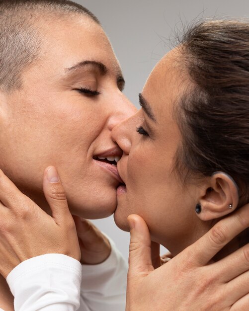 close up smiley women kissing