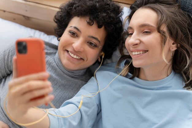 Close up smiley women with smartphone