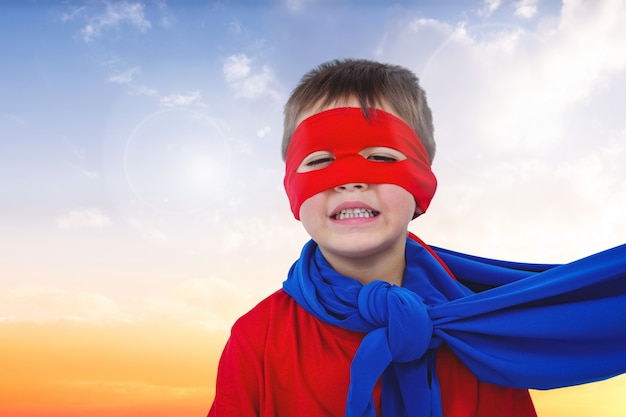 Close-up of smiling boy with red mask