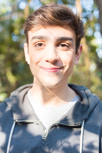 Close-up of smiling boy with sportswear at dawn